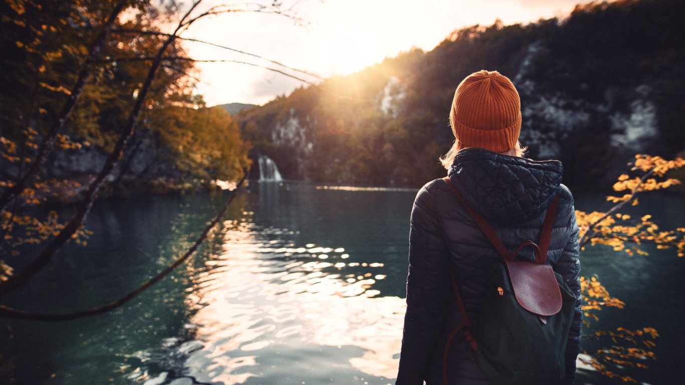 Person standing in front of lake